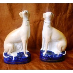 Pair seated Greyhounds